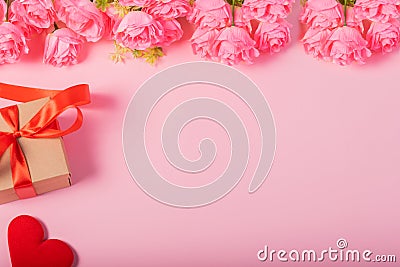 Valentines day and love concept. One small gift box with red heart and flowers on pink background Stock Photo