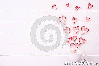 Valentines day and love concept. Red paper hearts splash out from white coffee cup Stock Photo