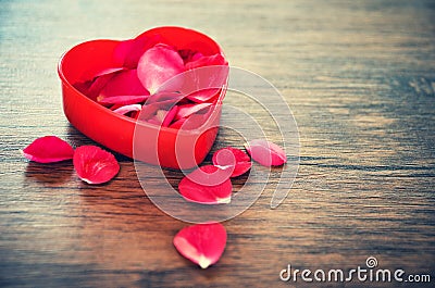 Valentines day love heart concept Open Red heart box decorated with red roses petals on wooden Stock Photo