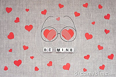 Valentines Day mockup, greeting card with many red hearts, two big heart in doodle eyeglasses and text BE MINE on linen fabric Stock Photo