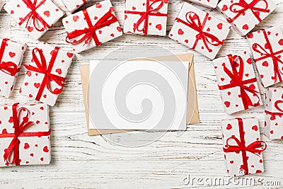 Valentines day romantic background. envelope card with gift boxes and heart on a wooden background Stock Photo