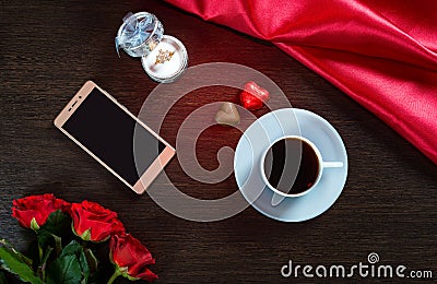 Valentines Day romantic background with wedding ring, rose flowers, smartphone, cup of coffee and chocolate candy Stock Photo