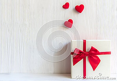 Valentines day white gift box with a red bow on white wall background, Stock Photo