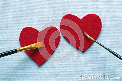 Valentines. Drawing of two red hearts with two paintbrushes. Copy space Stock Photo