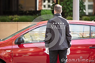 Valet Standing In Front Of Car Stock Photo