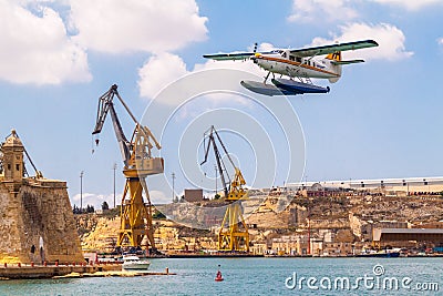 Valetta, Malta. Harbour Air seaplane De Havilland Canada DHC-3 Turbine Otter 9H-AFA is taking off in the Grand Harbour, Senglea. Editorial Stock Photo