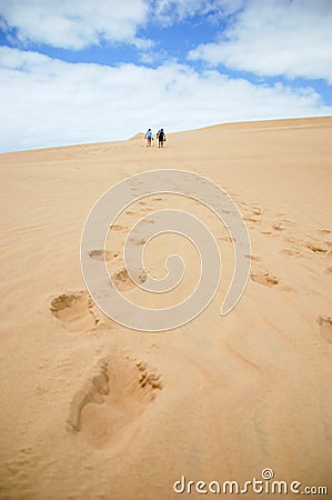 A couple hiking a sand dune Editorial Stock Photo