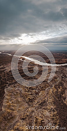 Valle de la Luna Amarillo on a cloudy day at sunset. Aerial view. Rio Negro, Argentina Stock Photo