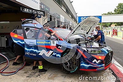 Hyundai team people tuning electric racing car in asphalt circuit pit Editorial Stock Photo
