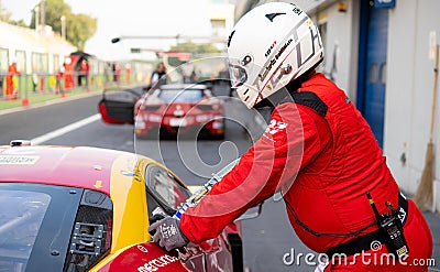 Pit stop refuelling car race. Mechanic with safety equipment in action Editorial Stock Photo