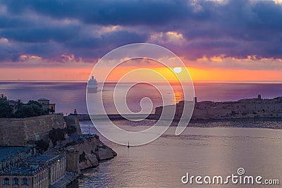 Valletta harbour in colorful sunrise, Malta Stock Photo