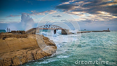 Valletta, Malta - Amazing huge waves over the Breakwater bridge Stock Photo