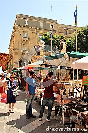 Valletta, Malta, July 2014. Lively movement of people on the main street of the city during a religious holiday. Editorial Stock Photo