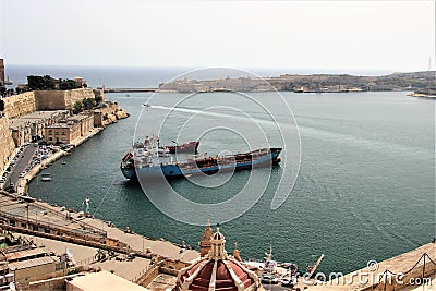 Valletta, Malta, July 2014. View of the old town and cargo ships in the harbor Editorial Stock Photo
