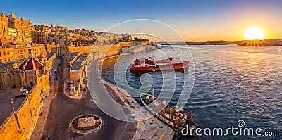 Valletta, Malta - Panoramic skyline view of Valletta and the Grand Harbor with beautiful sunrise, ships Stock Photo