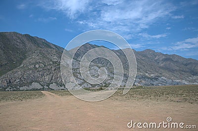 The valley at the foot of rocky massifs. Mountain Altai. Stock Photo