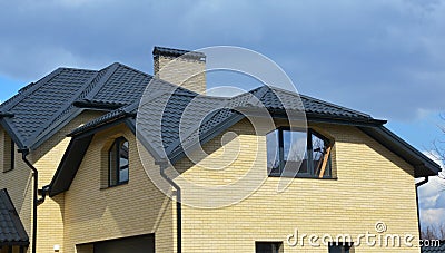 Valley and gable new modern house ceramic tiled roofing construction. Brick house with problem gable roof roofing construction and Stock Photo
