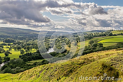 A valley with sheep and rain clouds Stock Photo