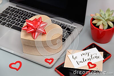 Valnetines day gift bos with a bow on laptop near card BE MY VALENTINE Stock Photo