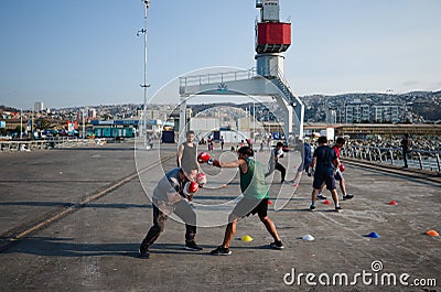 Men boxing at Muelle Baron pier with portal crane in background. Boxing training outdoors. Editorial Stock Photo