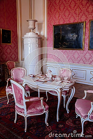 Valtice, Southern Moravia, Czech Republic, 04 July 2021: Castle interior with baroque furniture, dining room or pink salon with Editorial Stock Photo