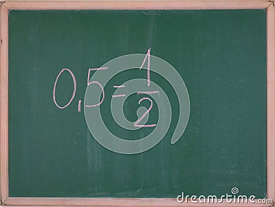 Values in mathematics 0.5 = 1/2,written on the school board Stock Photo