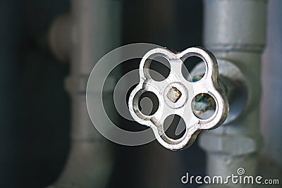 The valve of the water supply system close-up. Crane and pipes in the basement with copy space Stock Photo