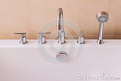 Valves, faucet and shower head of of modern style bath tub Stock Photo