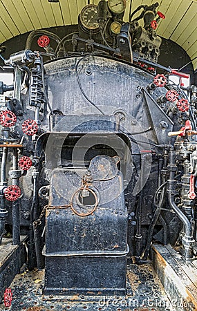 Valves and gauges on the water tank in the cab of an antique steam locomotive Editorial Stock Photo