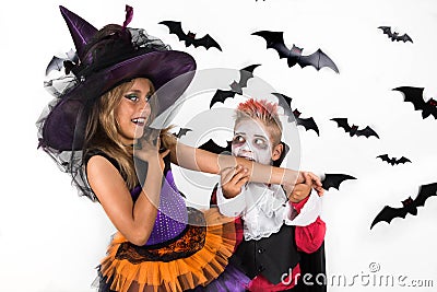 Vampire bite arm of a witch. Halloween kids, Happy scary girl and boy dressed up in halloween costumes of witch and vampire Stock Photo