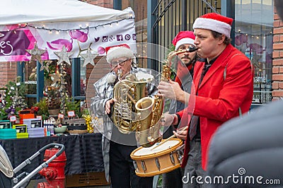 Vancouver, BC, Canada - 11/25/18: Jazz musicians playing saxophone, drum, and trumpet at Yaletown CandyTown even in Vancouver, B.C Editorial Stock Photo