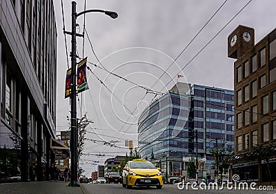 VANCOUVER, CANADA - JUNE 6, 2018: Granville street with yellow taxi and tall buildings in the morning. Editorial Stock Photo