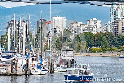 Ferry and docked boats under the Burrard Bridge Editorial Stock Photo