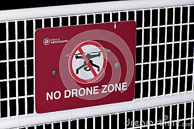 Red Warning Sign `No Drone Zone` found on the Canada Place fence at the Port of Vancouver Editorial Stock Photo