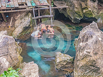 Unacquainted Local child playing or swimming in Clear water pool at Tham Chang cave Vangvieng City Laos Editorial Stock Photo