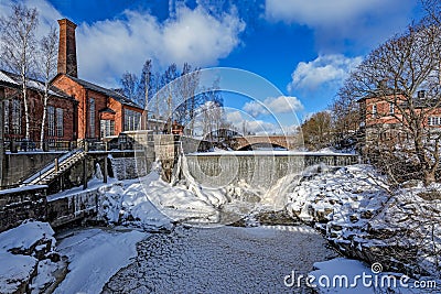 Waterfall in Vanhankaupunginkoski and old power station, Helsinki Stock Photo