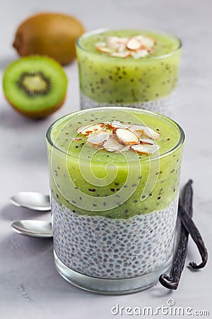 Vanilla chia pudding with kiwi, layered dessert, vertical Stock Photo