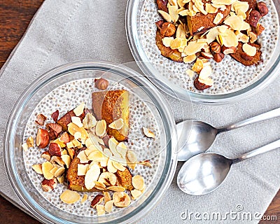 Vanilla chia seed pudding with baked prunes and nuts Stock Photo