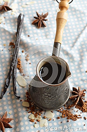 Vanilla coffee in the traditional cezve with a vanilla pod. Stock Photo