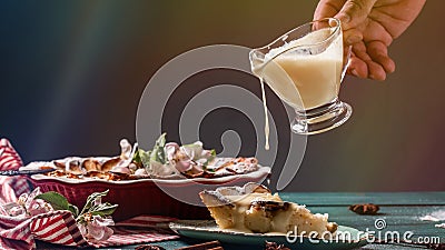 Vanilla cream pouring on cheesekace piece. Cheesecake with creamy sweet topping. Long banner format. space for text Stock Photo