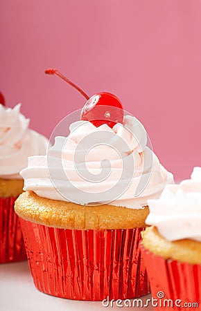 Vanilla cupcake with maraschino frosting Stock Photo