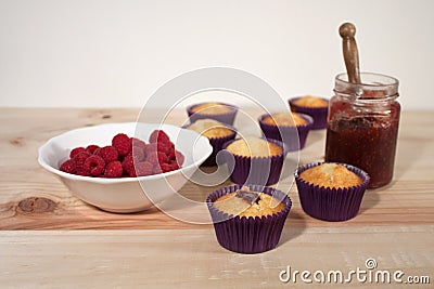 Vanilla cupcakes filled with jam and raspberry Stock Photo