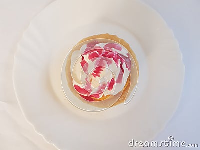 Vanilla flavored tart with whipped cream and raspberry topping. Stock Photo