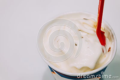 Vanilla frozen yogurts, frozen custards or soft ice creams in disposable blank paper cup, Selective Focus Stock Photo
