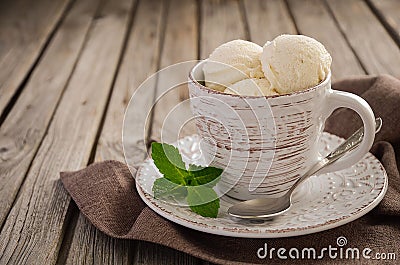 Vanilla ice cream in cup on rustic wooden background Stock Photo