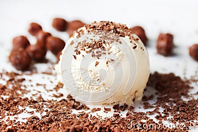 Vanilla ice cream scoop and chocolate crumbs. Coffee creme brulee tasty ice cream scoop with chocolate crumbs. Stock Photo