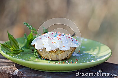 Vanilla muffin. Cupcake with white icing and colorful decorations Stock Photo