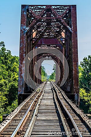 Vanishing Point View of an Old Railroad Trestle with an Old Iron Truss Bridge Over the Brazos River Stock Photo