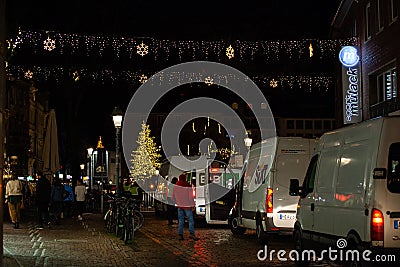 Vans waiting to get into aachen markt to tear down and clean up after christmas market Editorial Stock Photo