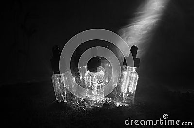 Vape concept. Smoke clouds and vape liquid bottles on dark background. Light effects. Useful as background or vape advertisement. Stock Photo